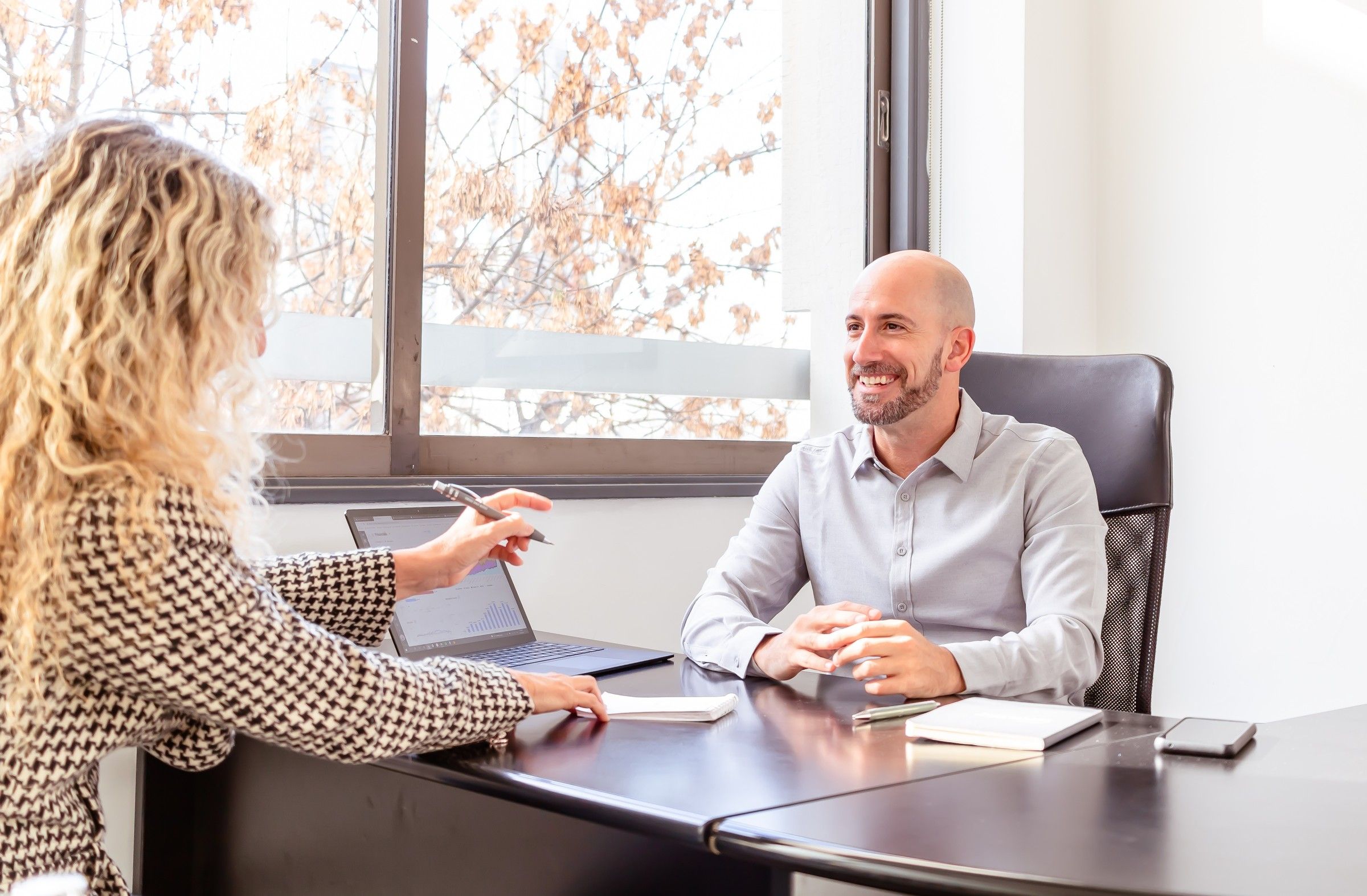 Mezar Chakwa at a desk with a client, talking through the work
